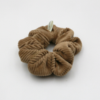 Corduroy Brown scrunchie with a brand tag on a white background