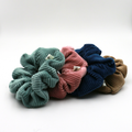 Corduroy Four colorful scrunchies on a white background