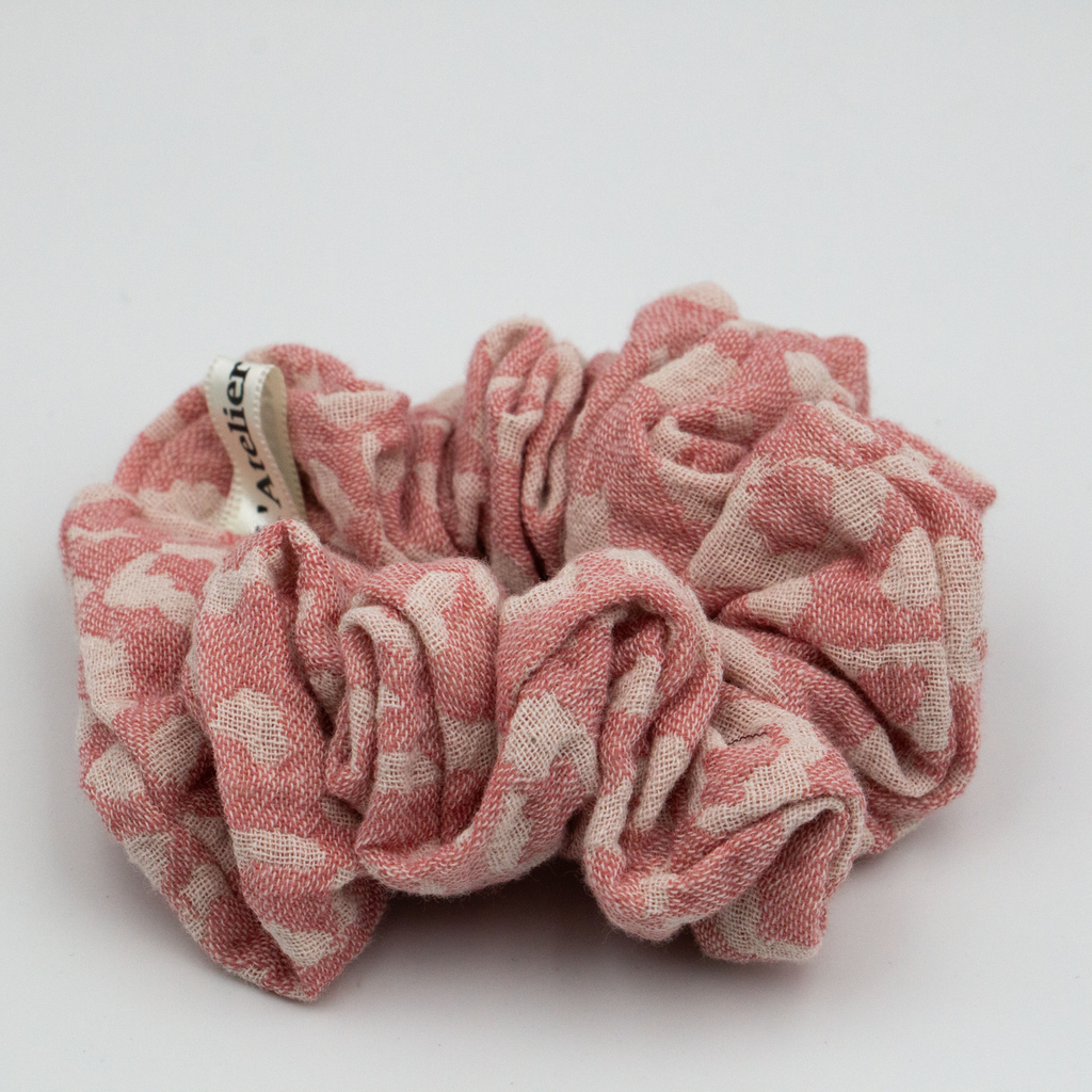 Pink and beige scrunchie on a white background