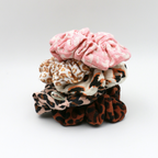 Stack of colorful scrunchies on a white background
