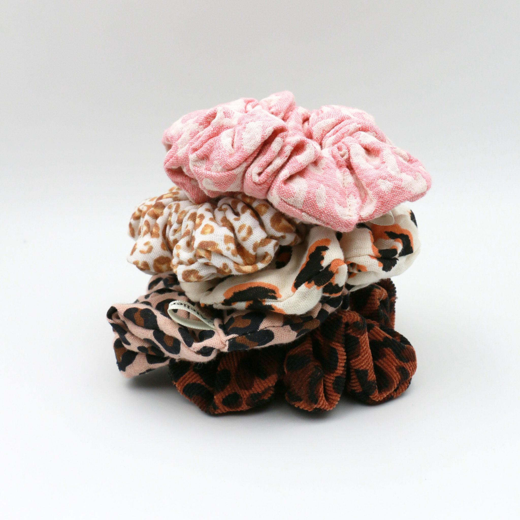 Stack of colorful scrunchies on a white background